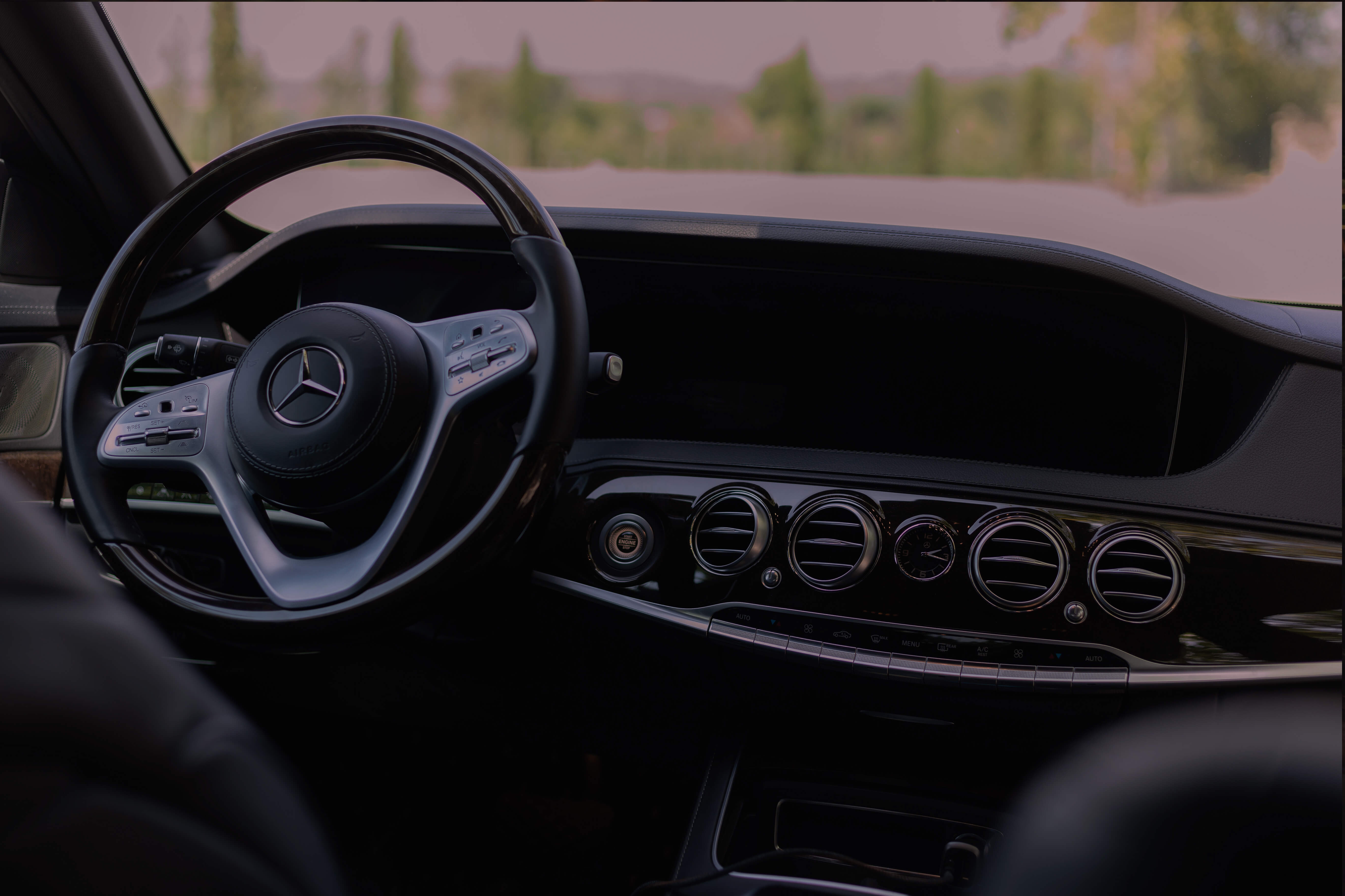 The steering wheel and clean dashboard of a Mercedes luxury vehicle